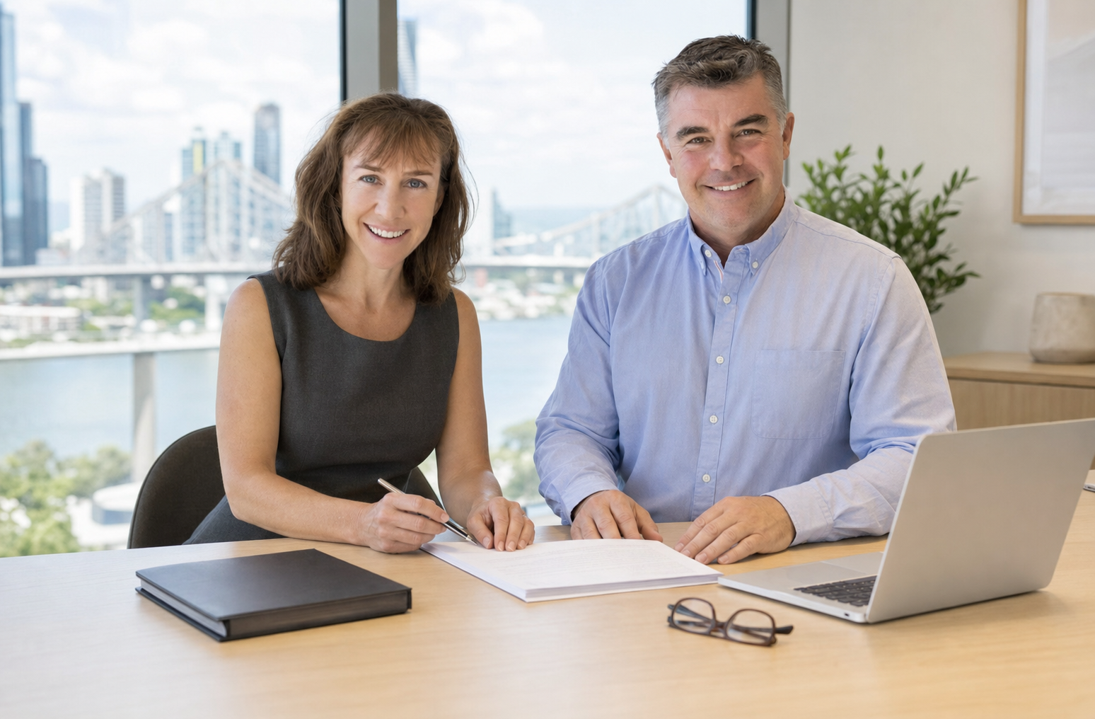 Rachel Stubbs and Brendan Hanks reviewing a document in their Brisbane office